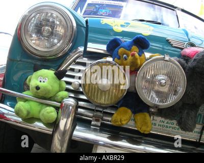 Vorderseite des blauen Mini mit Kuscheltieren hinter der vorderen Stoßstange Stockfoto