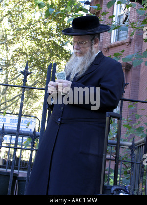 Jüdischer Mann in traditioneller Kleidung zählen Geld, USA, Brooklyn, New York Stockfoto