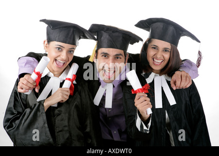 Porträt von drei Freunden halten Abschluss-Grad und jubeln Stockfoto