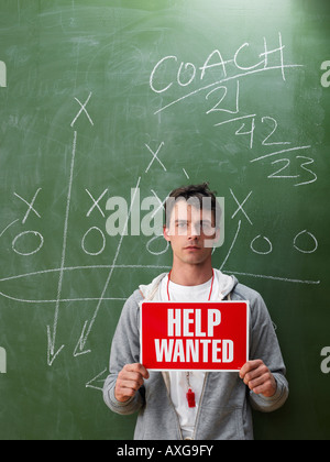 Coach Holding Hilfe wollte Zeichen Stockfoto