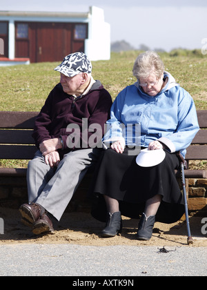 Altes Alter Ehepaar saß auf einer Bank mit Blick auf Meer Stockfoto