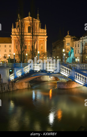 Tromstovje Triple Brücke über den Fluss Ljubljanica, Franziskanerkirche und Preseeren Square in der Nacht, Ljubljana, Slowenien Stockfoto