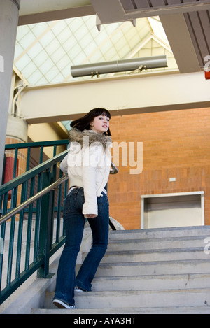 Porträt einer jungen Frau, die Treppe hinauf Stockfoto