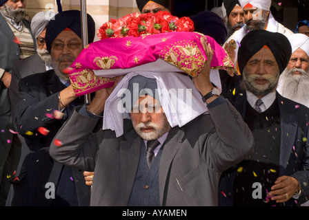 Sikh tragen heiliges Buch vor Tempel während Festivals Vaisakhi Hounslow Middlesex UK März 2008 Stockfoto