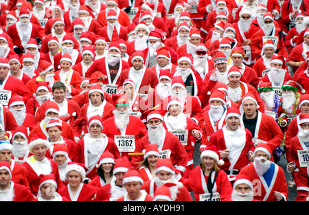 Mehr als 4000 Menschen aller Altersgruppen für die jährlichen Charity-Santa Fun Run in Newtown Powys Wales UK als Weihnachtsmann verkleidet Stockfoto