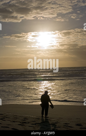Silhouette der Mann gerade Abends Sonnenuntergang über Meer und Strand Praia de Mira Portugal Stockfoto