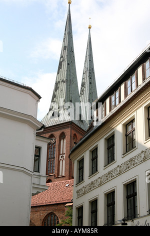 historische Kirche erhebt sich über andere Gebäude in einer belebten Straße Stockfoto