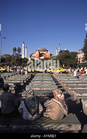ISTANBUL, TÜRKEI. Zwei Headscarved Frauen sitzen auf einer Bank in Sultanahmet, mit Aya Sofia hinter. 2005. Stockfoto