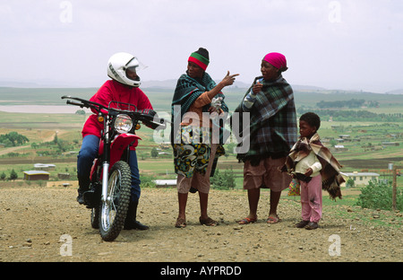 Trainierte Gesundheitsbesucherin auf dem „Riders for Health“-Programm, auf ihrem Motorrad und bat um eine Wegbeschreibung im ländlichen Lesotho Stockfoto