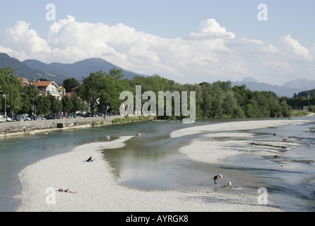 Menschen, die zum Sonnenbaden am Ufer Flusses von der Isar in Bad Tölz, Bayern. Stockfoto