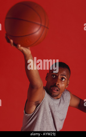 Männer Basketball-Spieler steigt für einen Schuss Stockfoto