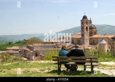 Touristischen paar sitzen auf einer Bank, Blick auf Urbino ist ein Renaissance-Stadt in Le Marche Italien Geburtsstadt des Malers Raphael Stockfoto