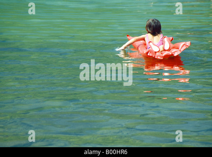 Mädchen auf einer Luftmatratze auf dem Wasser. Lago de Sanabria Nature Reserve. Provinz Zamora. Kastilien-León. Spanien. Stockfoto