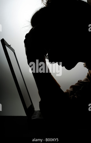 Müde Geschäftsfrau bei Computer-silhouette Stockfoto