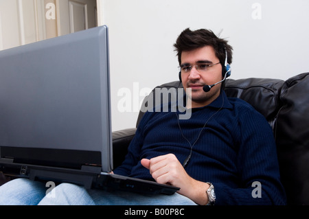 Mann mit Laptop-Computer mit Kopfhörer Stockfoto