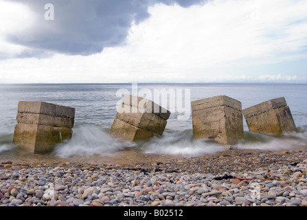 Eine Langzeitbelichtung der Wellen zwischen Strand Hindernisse. Stockfoto