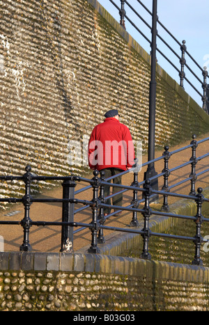 Älterer Mann zu Fuß bergauf zu oben auf den Klippen am Cromer an der Küste von Norfolk Stockfoto