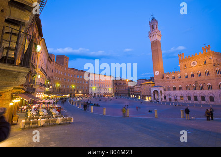 Torre del Mangia (Glockenturm) und Palazzo Pubblico (Rathaus) in Piazza del Campo in der historischen Altstadt in der Abenddämmerung Stockfoto