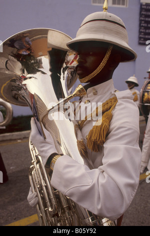 Intelligenter Bandsman des Royal Bermuda Regiment, in feinem Helm und weißer Uniform. Er besitzt ein hochpoliertes Tuba-Instrument Stockfoto