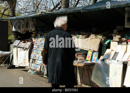 Ein Mann Surfen Bücher im Buch Anbieter entlang der Seine in Paris, Frankreich Stockfoto