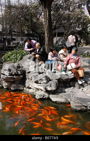 Chinesische Touristen füttern Fische im Humble Administratoren Garten in SUZHOU. China Stockfoto