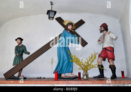 Statue von Jesus das Kreuz in einer Nische in der Altstadt von Hall, Tirol, Österreich Stockfoto