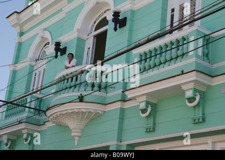 Mädchen auf Balkon eine türkisfarbene Kolonialhaus, Kuba, Camagueey Stockfoto