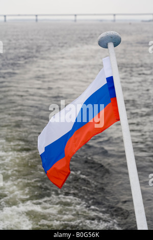 Russische Flagge auf Kreuzfahrtschiff auf Wolga mit neuen Straßenbrücke, Volgograd (in der Nähe von Stalingrad), Russland, Russische Föderation Stockfoto