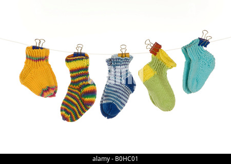 Verschiedene Babysocken von einer Wäscheleine hängen Stockfoto