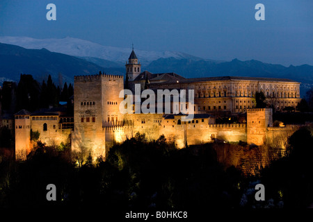 Maurischen Alhambra Palast unter Flutlicht in der Dämmerung, beleuchtet in der Abenddämmerung, Sierra Nevada an der Rückseite, angesehen vom Mirador San Stockfoto