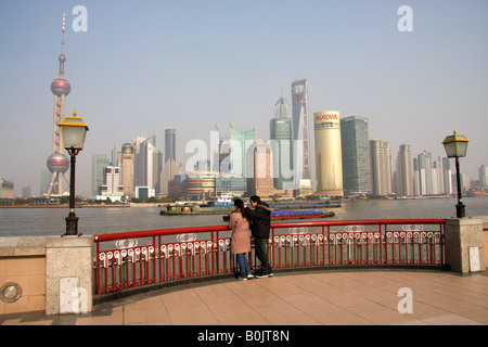 Chinesisches Ehepaar auf der Suche über den Huangpu-Fluss auf die Skyline von Pudong, Shanghai. Stockfoto