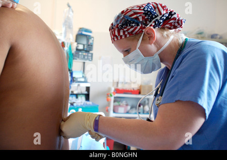 Eine Krankenschwester Anästhesisten verwaltet eine spinale Injektion während der Vorbereitung eines Patienten für die Operation während einer 2006 chirurgischen Mission nach Sula Stockfoto