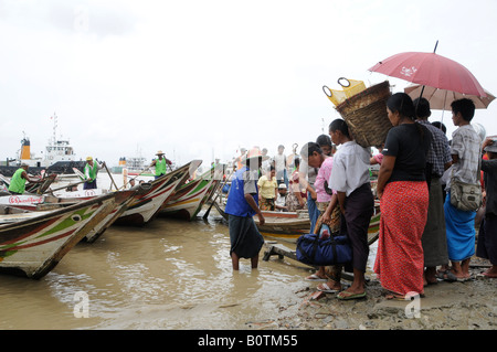 Auf dem Weg nach Dallah im Hafen von Yangon, Myanmar, Burma, steigen Menschen in Fährschiffe im Fluss Irrawadden ein Stockfoto