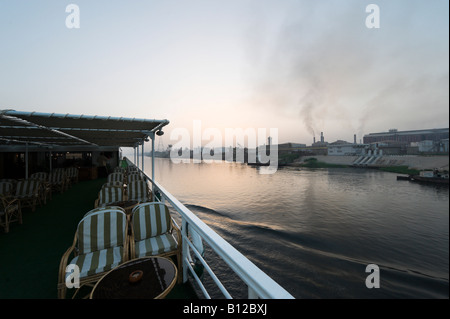 Industrielle Verschmutzung von der Fabrik an den Ufern des Nils in der Morgendämmerung vom Deck des Niltals Nil Cruiser, Luxor, Ägypten Stockfoto