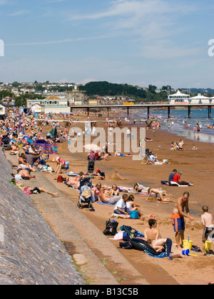 Urlauber genießen die Sommersonne am Strand und am Freizeitpier. Paignton, Devon, Großbritannien Stockfoto