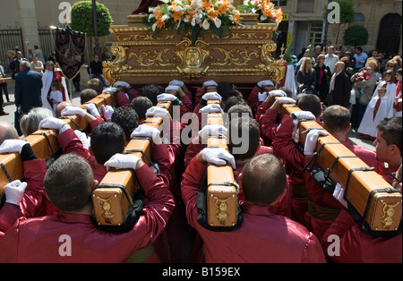 Büßer tragen religiöse Statuen während Osterprozession in Crevillente Murcia Spanien Stockfoto