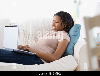 African American schwangere Tippen auf laptop Stockfoto