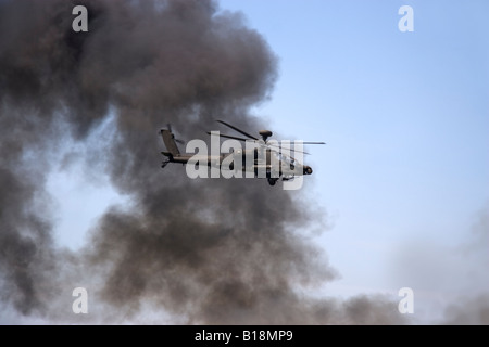 Rauch steigt bei einem simulierten Angriff durch ein WAH-64 Apache Kampfhubschrauber der britischen Armee während der Biggin Hill Airshow Stockfoto