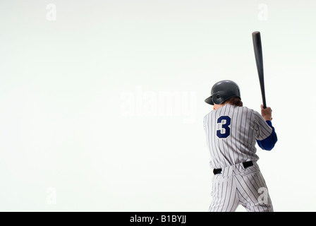 Baseball-Spieler stehen mit Fledermaus Stockfoto