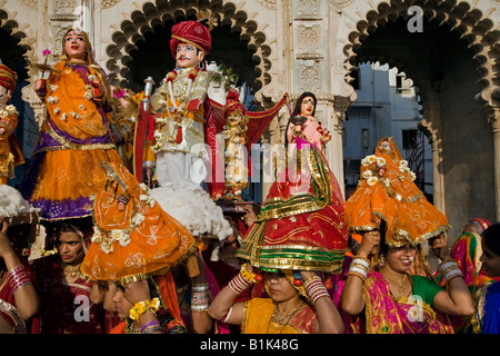 Rajasthani Frauen tragen Bildnisse von Shiva und seiner Frau Parvati auf dem GANGUR-FESTIVAL oder das MEWAR-FESTIVAL in UDAIPUR, RAJASTHAN Stockfoto