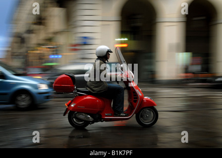 Ein Roller fährt durch den Regen entlang Via Po in Turin, Piemont, Italien. Stockfoto