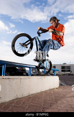 BMX-Fahrer tun "Icepick Stall' auf einer Schiene Stockfoto