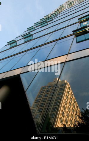 Spiegelung in der verglasten Fassade des Bahn-Towers, der den Hauptsitz der Deutschen Bahn am Potsdamer Platz beherbergt. Berlin, Deutschland Stockfoto