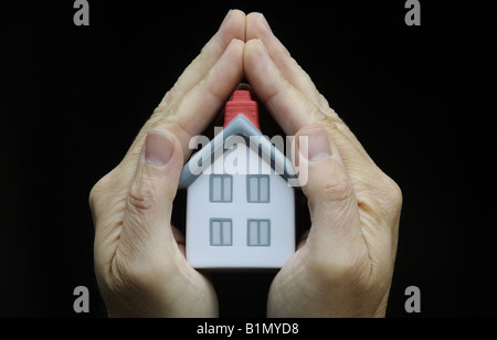 MUSTERHAUS IN STATT A MANS HAND RE IMMOBILIEN MARKT HAUS PREISE HOME KÄUFER WIRTSCHAFT IMMOBILIENMAKLER VERSICHERUNGSSCHUTZ UK. Stockfoto