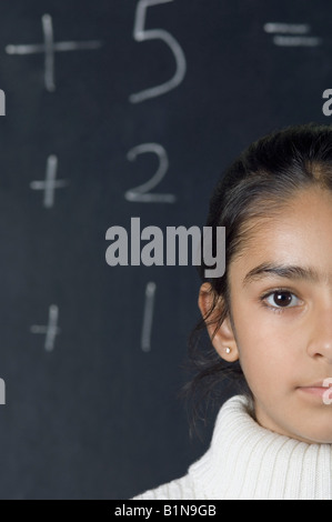 Porträt eines Mädchens vor einer Tafel Stockfoto