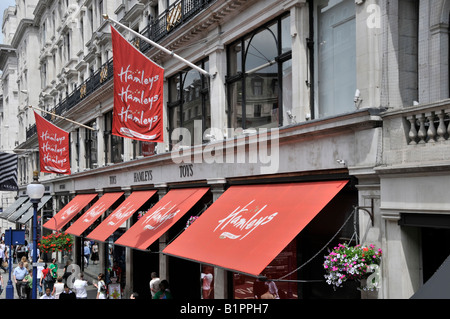 Käufer Fuß den Bürgersteig der Regent Street vor dem Shopfronts der Hamleys-Spielzeug-Shop Stockfoto