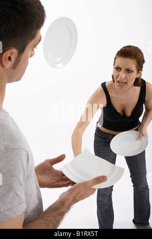 Frau eines Mannes Kopf während eines Streits einen Teller bewerfen Stockfoto