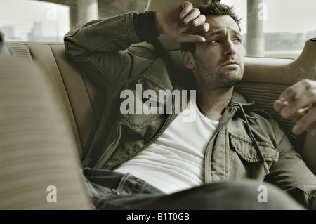 31 Jahre alter Mann verkleidet als James Dean im Auto Stockfoto