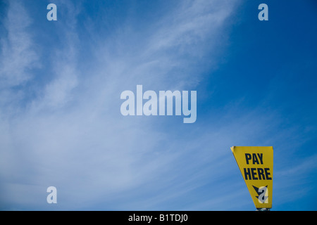 "Bezahlen Sie hier" Parkplatz Schild wieder blauen Himmel und weiße Wolken für Zahlen und zeigt Parkplatz in England UK GB British Isles Stockfoto