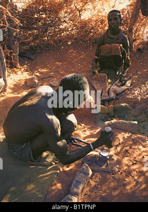 Samburu Schmied Gestaltung ein Stück Metall, einer Armband zu seiner Frau machen funktioniert Ziegenleder Balg Kenia in Ostafrika Stockfoto